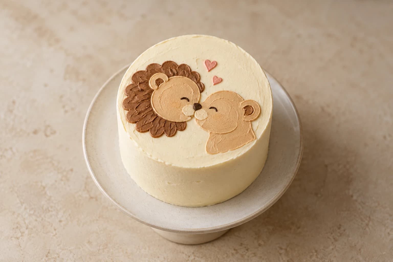 Original concept of a small ivory bento cake with an affectionate original lion couple illustration and two pink buttercream hearts.