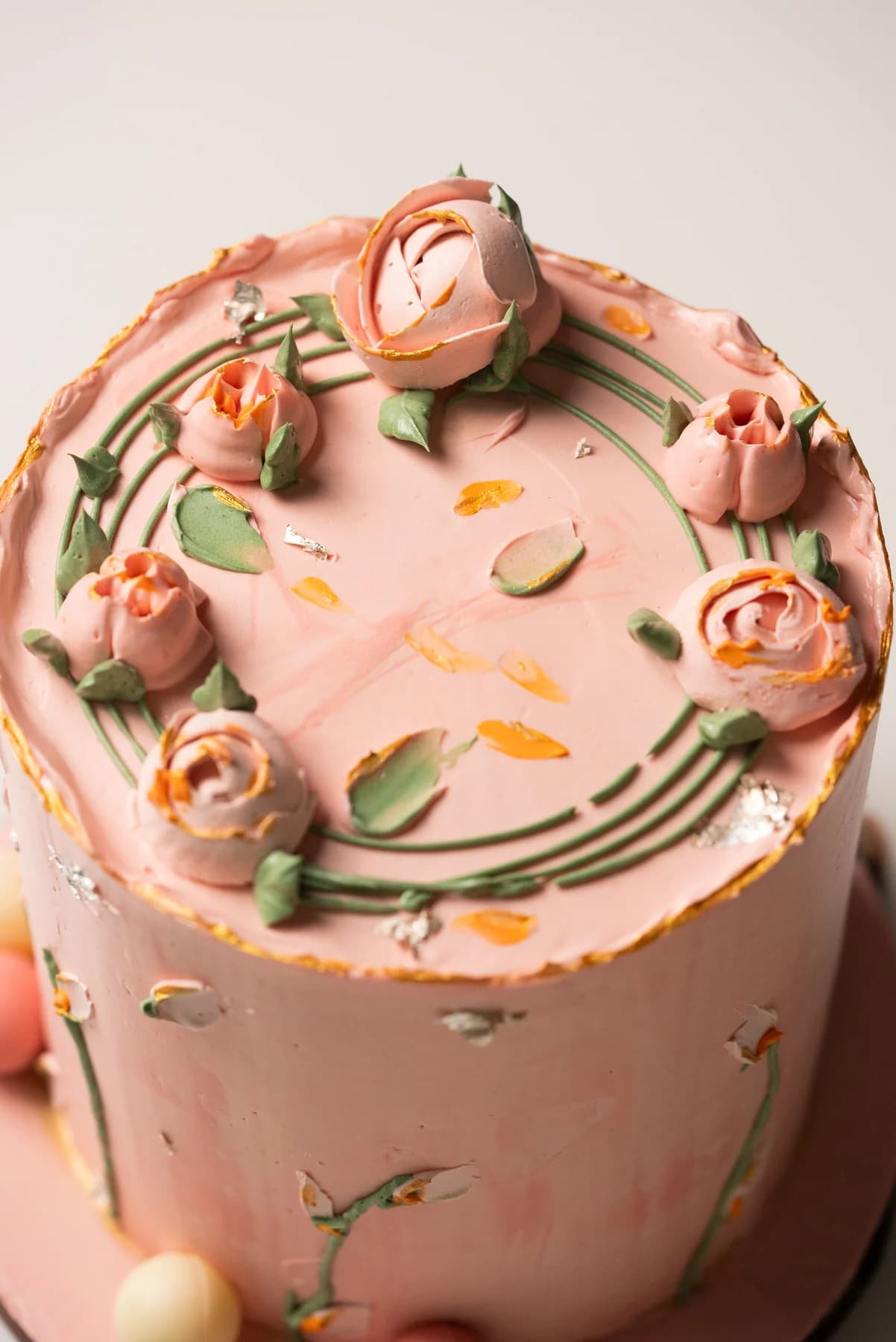 Pink cake with sculpted pink roses and green stems