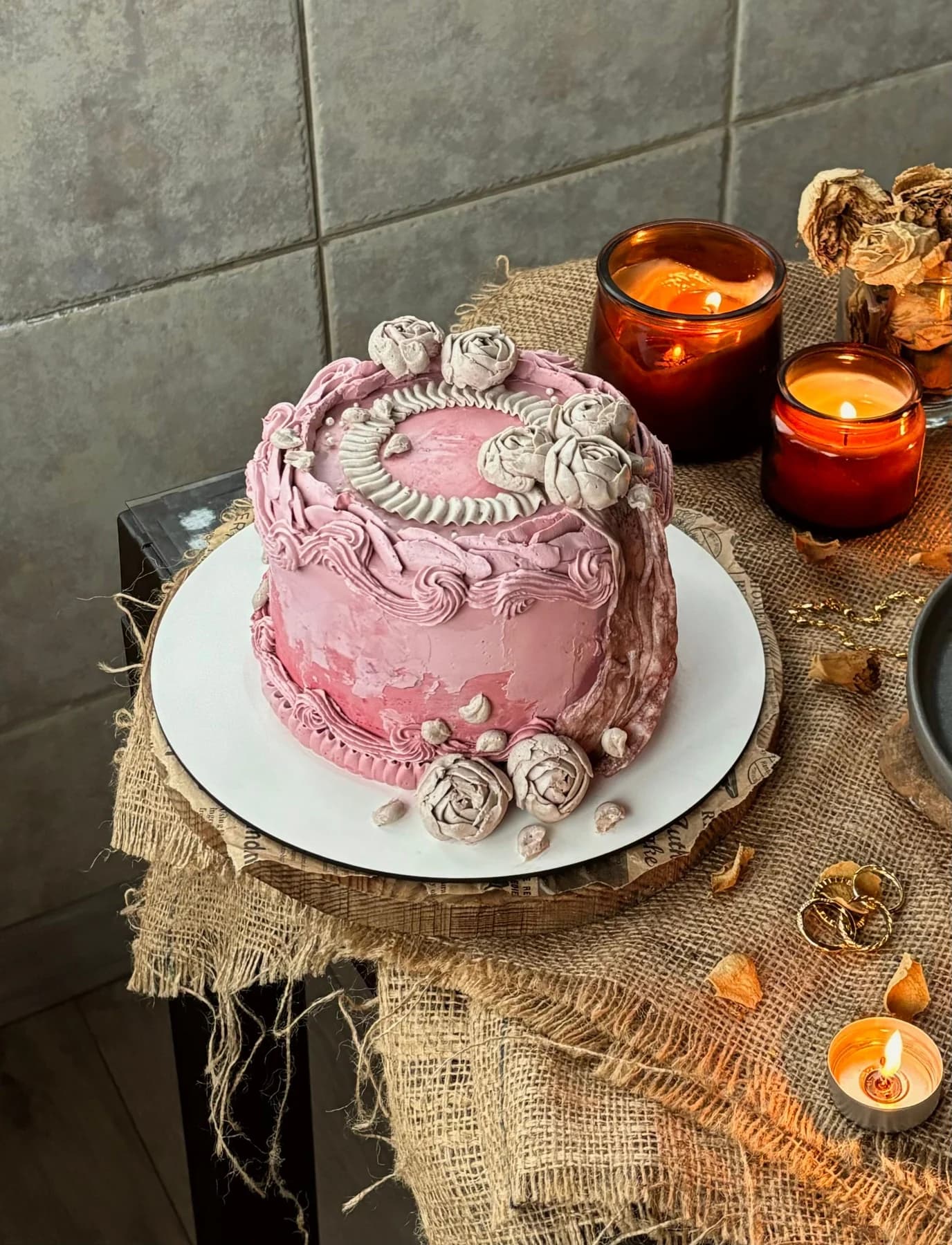 Pink vintage-style cake with ivory piped swags, shell borders and rosettes