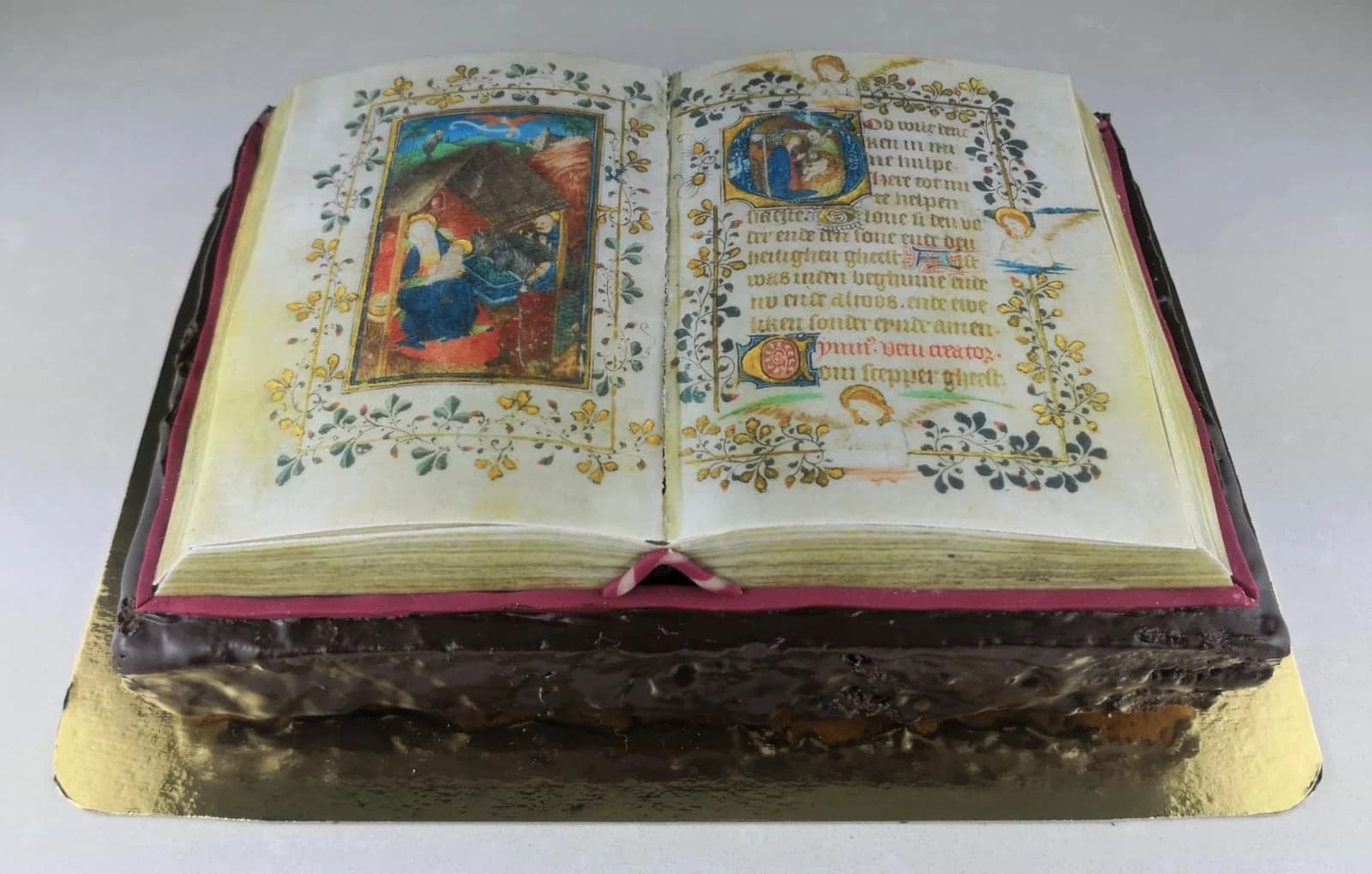 A cake shaped like an open illuminated book