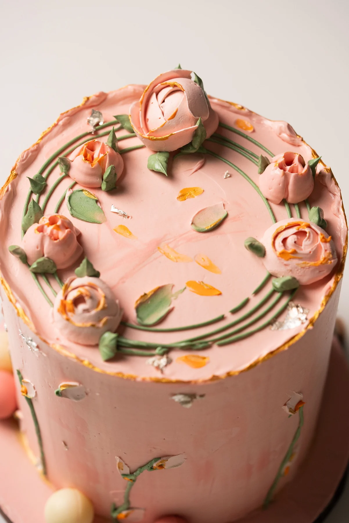 Pink cake with sculpted pink roses and green stems