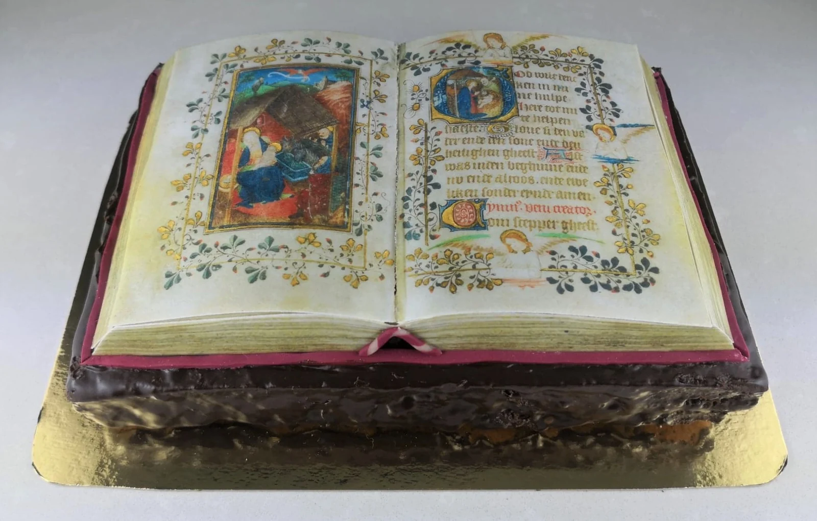 A cake shaped like an open illuminated book